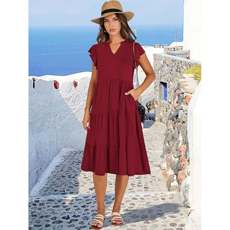 Detailed shot of the flutter sleeves and V-neck on a women's comfortable tiered midi dress.