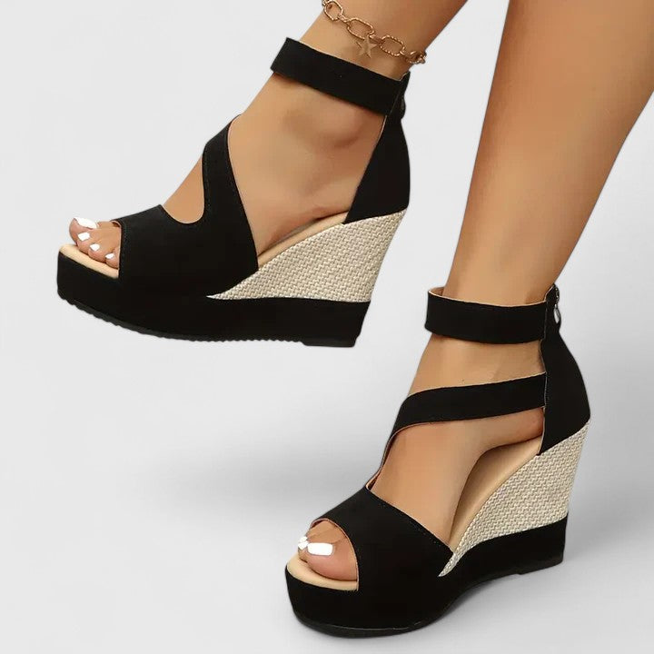 Close-up of women's orthopedic wedge sandal with superior arch support, elastic strap & cushioned sole for all-day comfort.