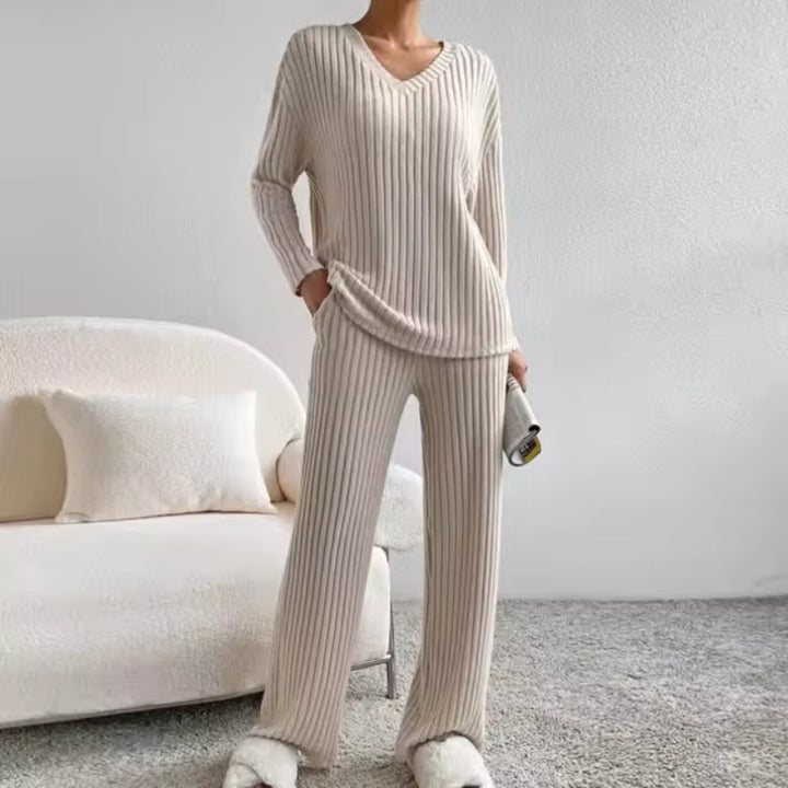 Women's cozy ribbed knit loungewear set. Two-piece matching outfit with V-neck top & comfortable trousers for casual wear.