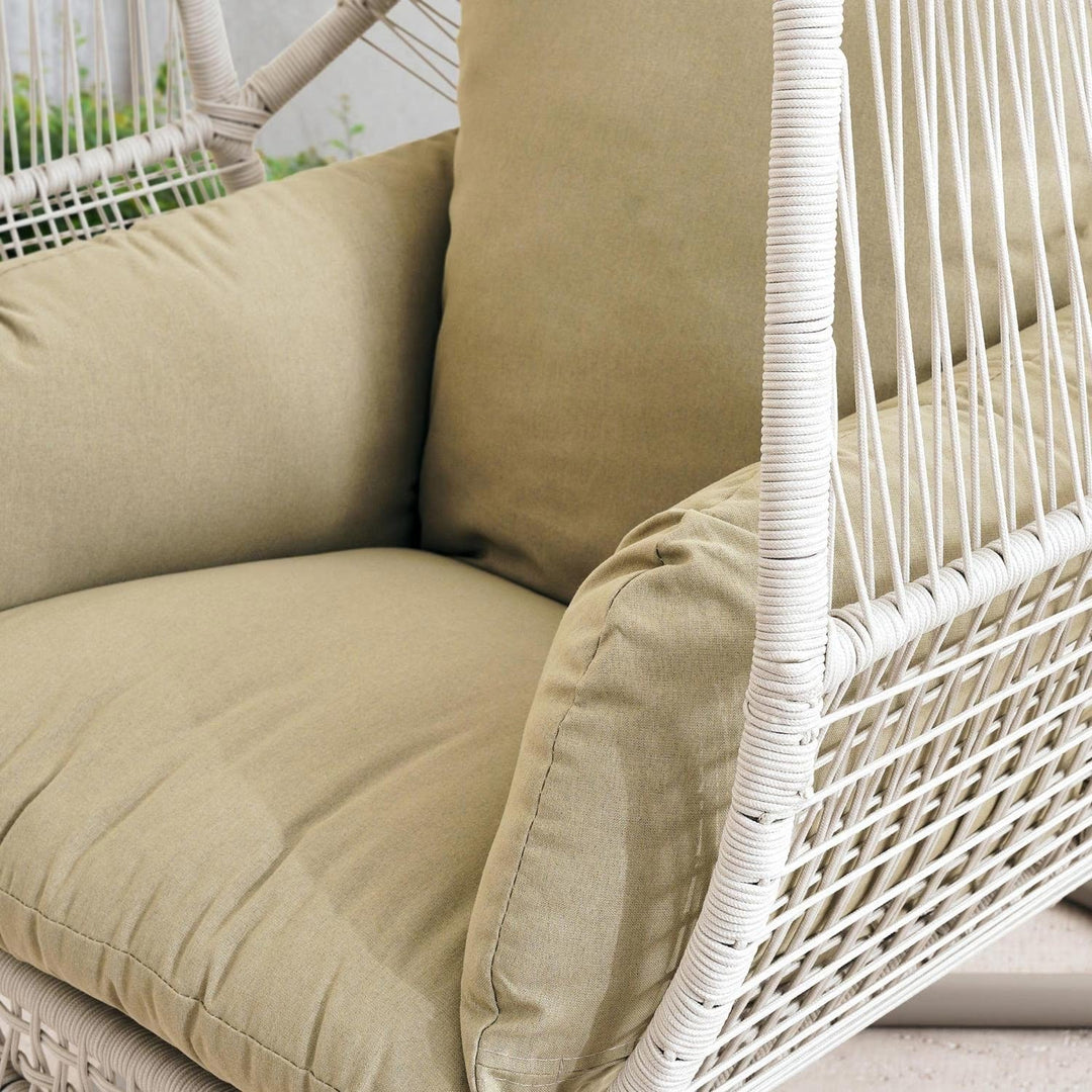 Relaxing cream hanging egg chair swing, ideal outdoor garden decor with soft removable cushion.