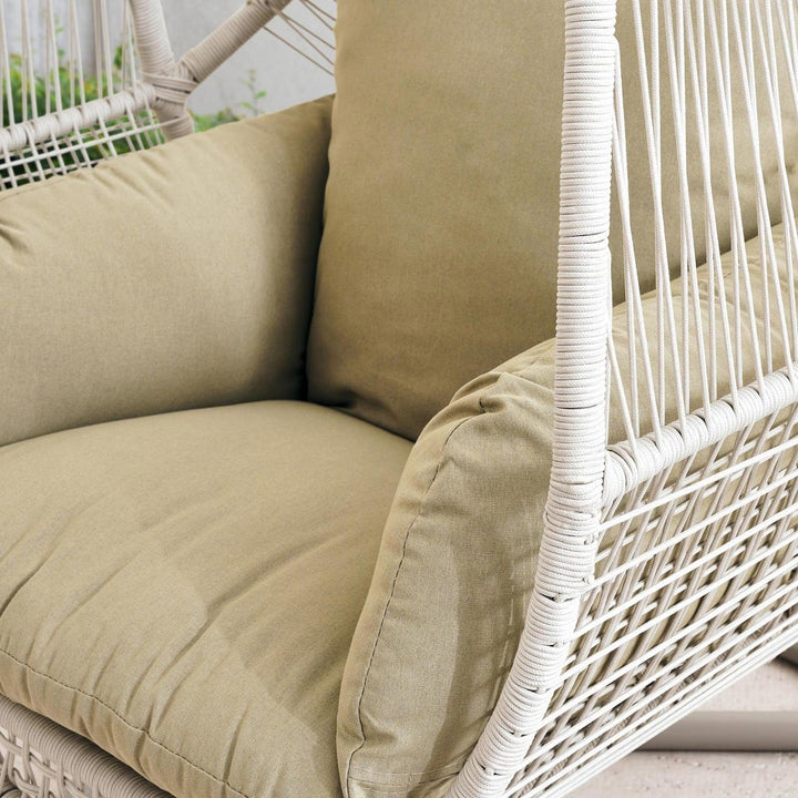 Relaxing cream hanging egg chair swing, ideal outdoor garden decor with soft removable cushion.