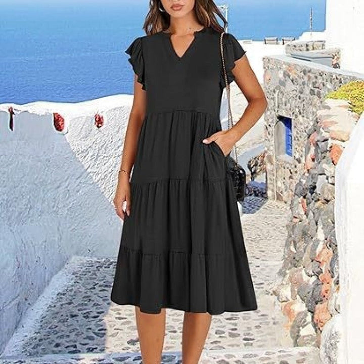 Stylish women's V-neck midi dress featuring a comfortable tiered skirt and practical pockets.