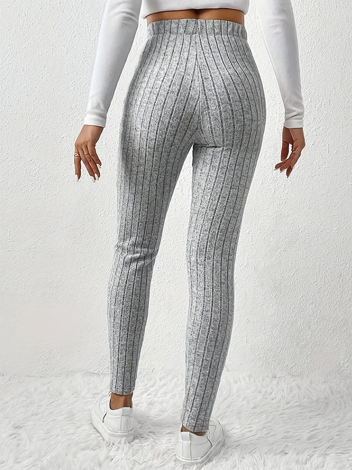 Close-up of ribbed texture on comfortable high-rise women's leggings, ideal for athleisure style.