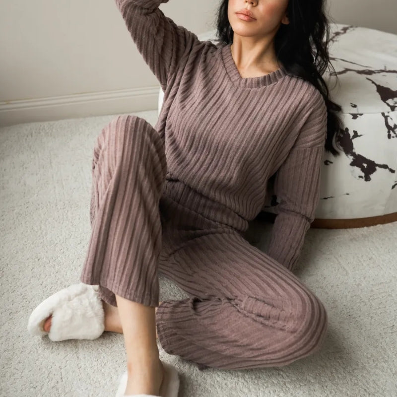 Close-up of women's cozy ribbed knit loungewear fabric. Soft texture detail of the two-piece set, perfect for comfort.