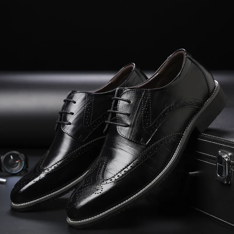 Detailed men's brogue oxford dress shoes, classic formal footwear with intricate perforations.