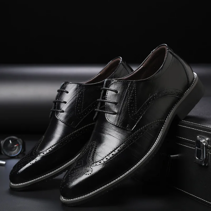 Detailed men's brogue oxford dress shoes, classic formal footwear with intricate perforations.