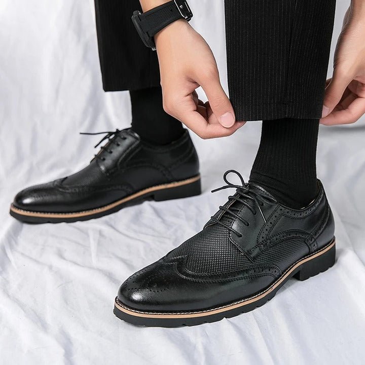 Versatile men's formal black leather brogues, offering a classic and professional look for business or smart casual styling.
