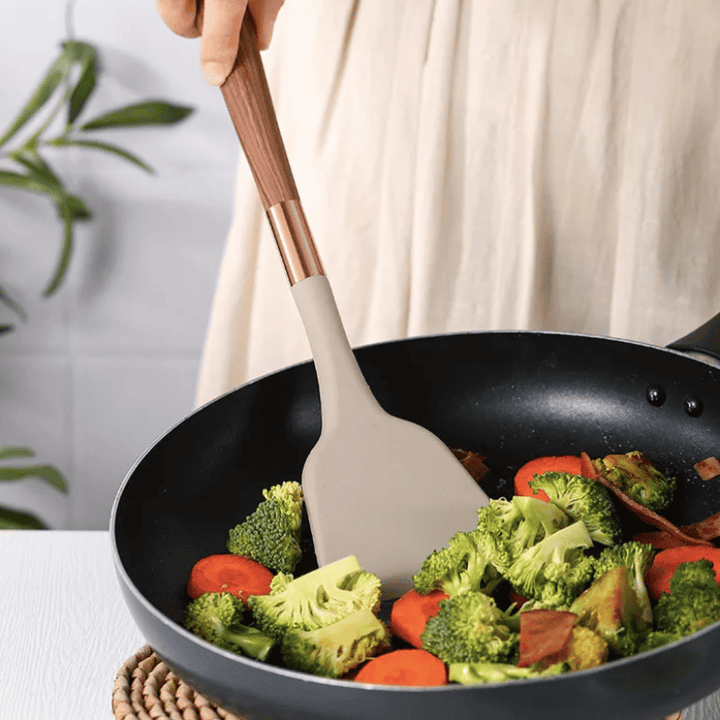 Versatile 10-piece silicone utensil set for scratch-free cooking. Features wooden handles & dishwasher-safe design.