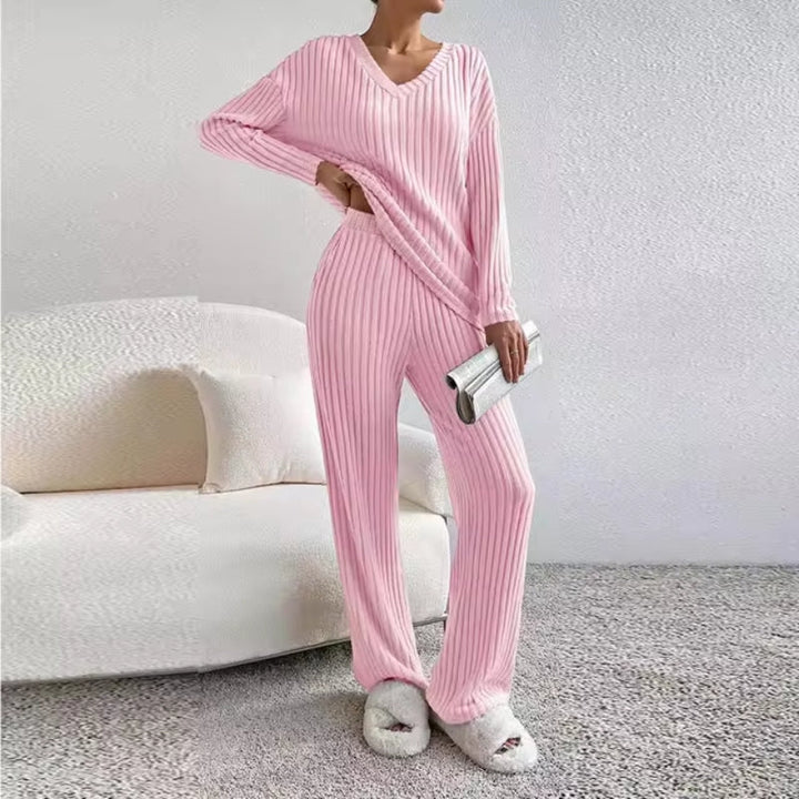 Flat lay of women's cozy ribbed knit two-piece matching loungewear set. Soft V-neck top & comfortable trousers, unworn.
