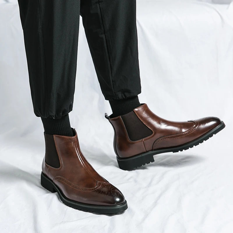 Man wearing comfortable men's brogue chelsea boots, paired with smart trousers for a sharp look.