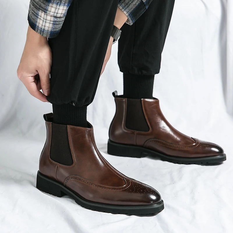 Classic men's formal chelsea boots with sophisticated brogue work, a stylish wardrobe essential.