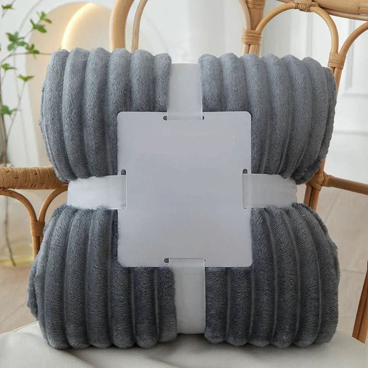 Plush striped flannel fleece blanket, offering cozy warmth and softness for your home.