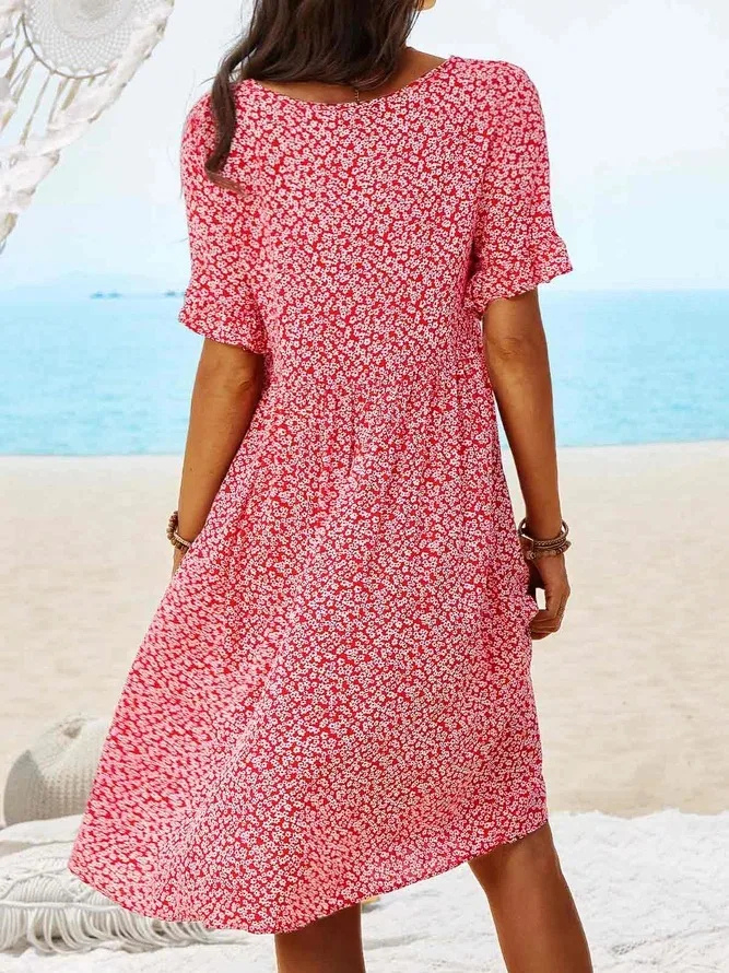 Close-up of a women's ditsy floral print on a flutter sleeve mini dress, ideal for vacation.