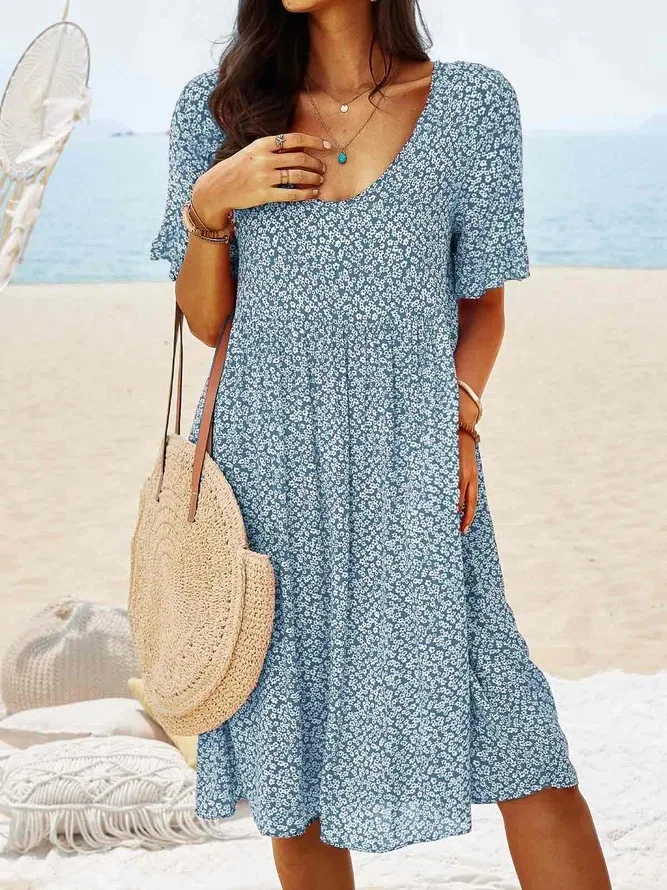 Woman wearing a ditsy floral flutter sleeve mini dress, perfect casual style for a summer day.