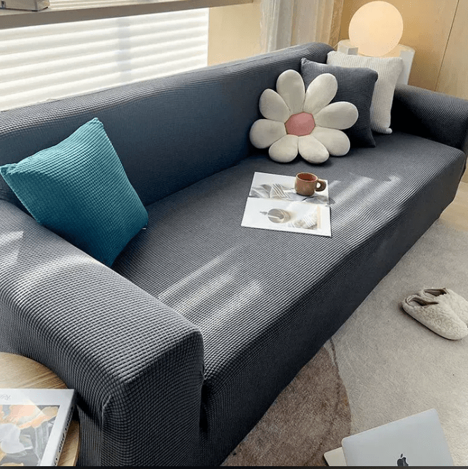 Stylish non-slip jacquard sofa protector cover in grey, safeguarding furniture from spills & pets. Perfect for living room.