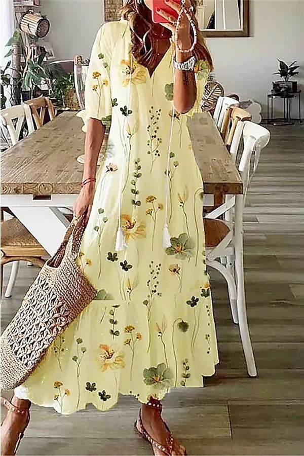 Effortless women's floral maxi dress with a comfortable V-neck and stylish tassel details.