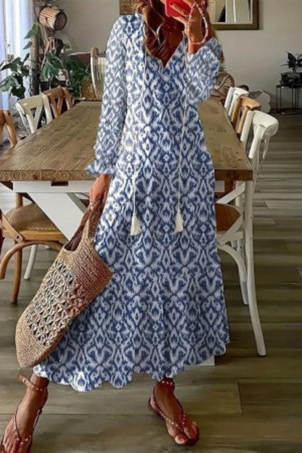 Stylish women's floral V-neck maxi dress with tassels, ideal for a casual summer holiday outfit.
