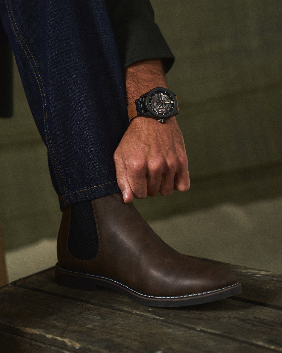 Man wearing comfortable black leather Chelsea boots, suitable for all-day style & men's fashion.