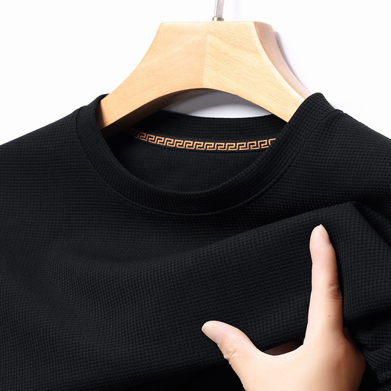 Close-up of a men's textured waffle knit t-shirt, highlighting its premium fabric.