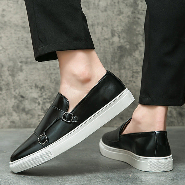 Men's elegant monk strap loafers worn with smart trousers, perfect for a refined, classic look.