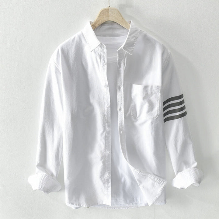 Model in men's versatile long-sleeve button-up shirt. Effortless smart casual style, a key men's fashion essential.