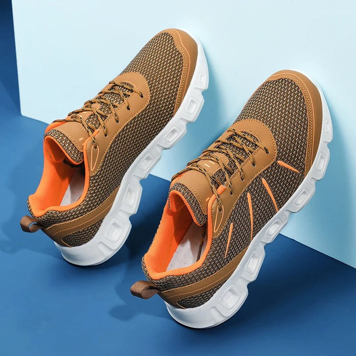 Front view of gray unisex running shoes, showcasing lightweight design, ultimate comfort, and breathable material.