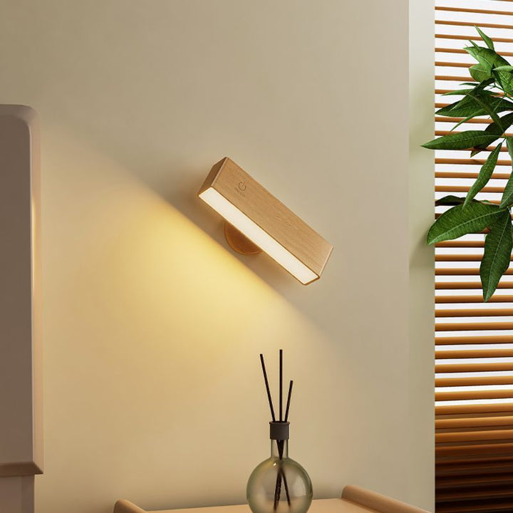 Contemporary rechargeable wood wall light, LED & remote-controlled, enhances modern home interiors.
