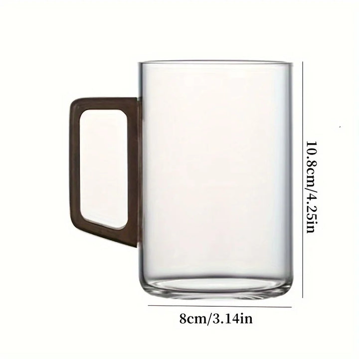 Clear borosilicate glass mug with a refined walnut wood handle, ideal for hot beverages & kitchen decor.