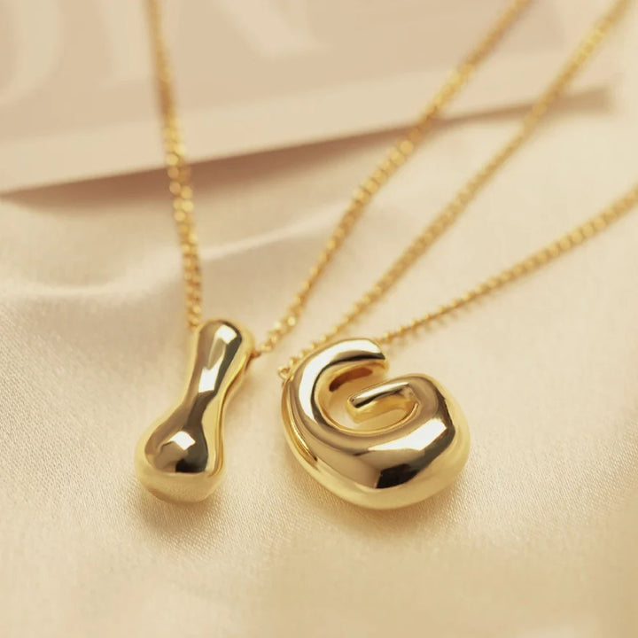 Chic women's golden initial letter pendant necklace. Gold-tone personalized jewelry, ideal for everyday fashion.