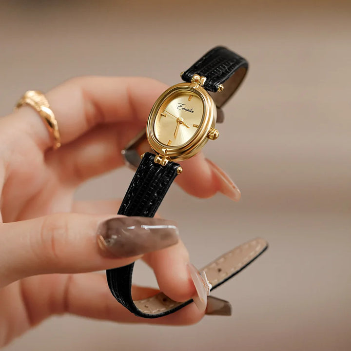 Brown women's elegant slim wristwatch with a sleek rectangle dial. Modern and sophisticated accessory.