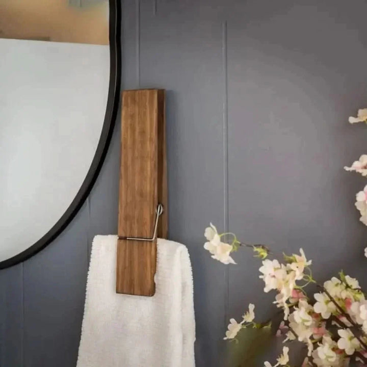 Modern minimalist wood towel holder clip for bathroom organization. Stylish wall mount accessory for spa-like spaces.