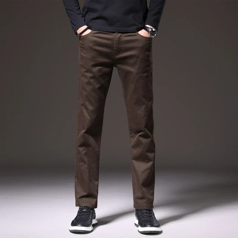 Man wearing comfortable men's khaki cotton chino trousers. Perfect for versatile casual or smart-casual outfits.