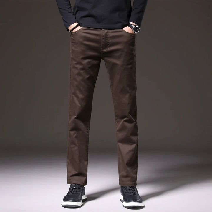 Man wearing comfortable men's khaki cotton chino trousers. Perfect for versatile casual or smart-casual outfits.