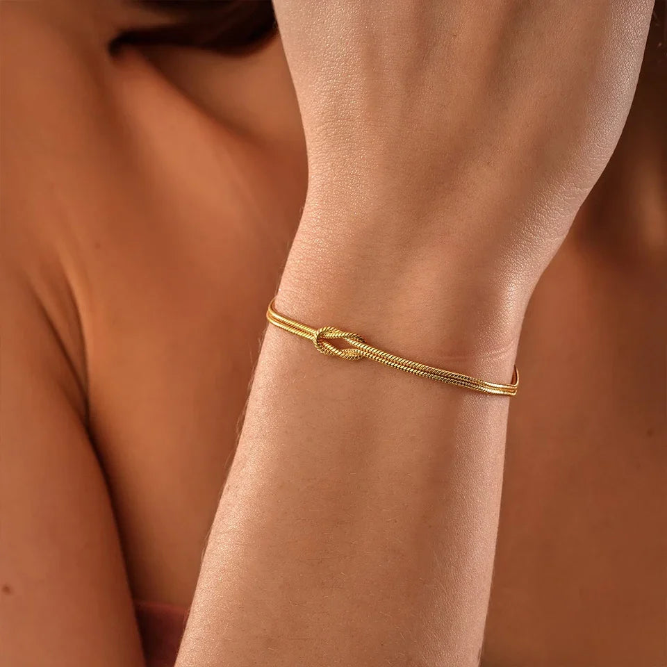 Modern silver-tone Endless Knot bracelet. Durable, minimalist stainless steel unisex jewelry.