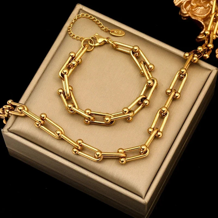 Close-up of women's golden polished link chain necklace showcasing elegant craftsmanship.