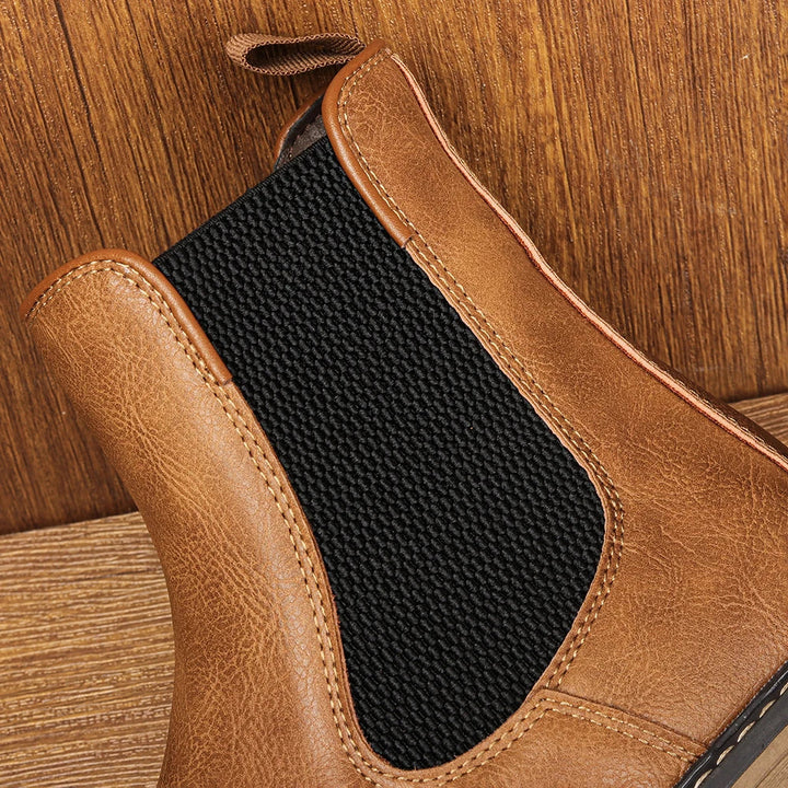 Fashionable men's winter boots; pull-on Chelsea design with superior comfort and a unique blue sole detail.