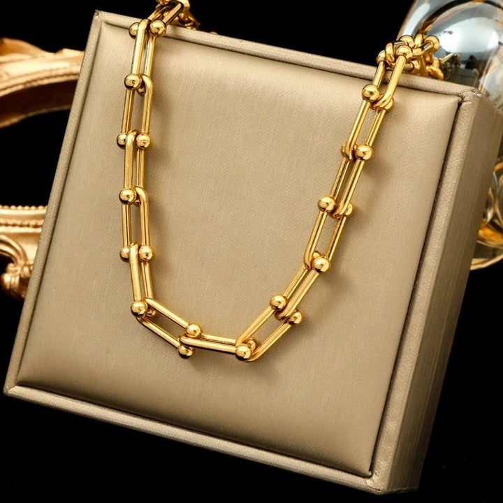 Modern women's golden polished link chain jewelry, enhancing any fashion look with elegance.