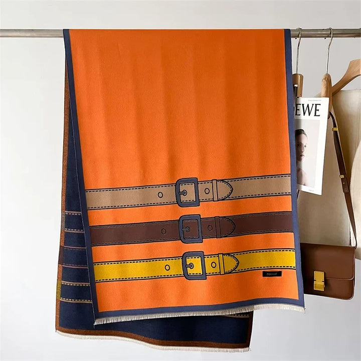 Elegant pink cashmere blend scarf, a soft luxury wrap with a trendy belt buckle pattern for winter fashion.