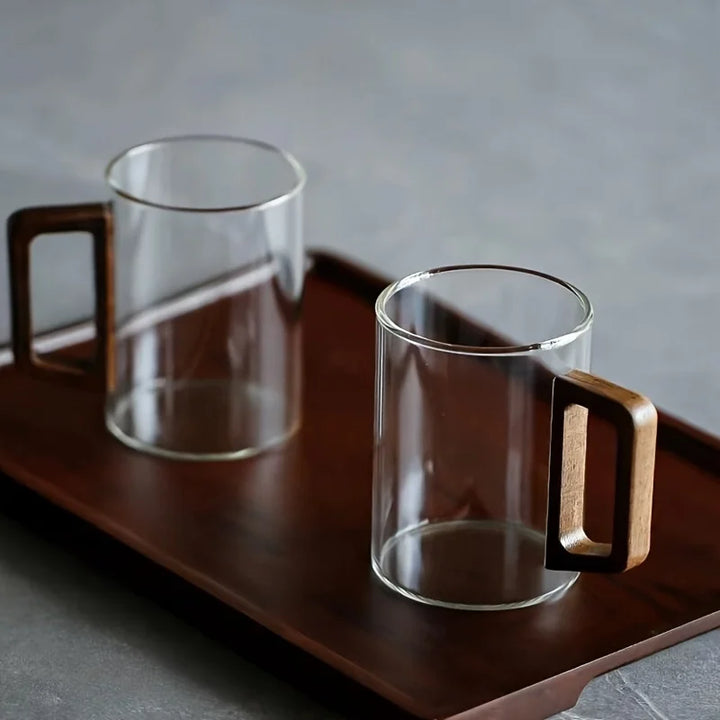 Elegant glass coffee mug with a sturdy walnut handle, a premium addition to any kitchen or home drinkware collection.