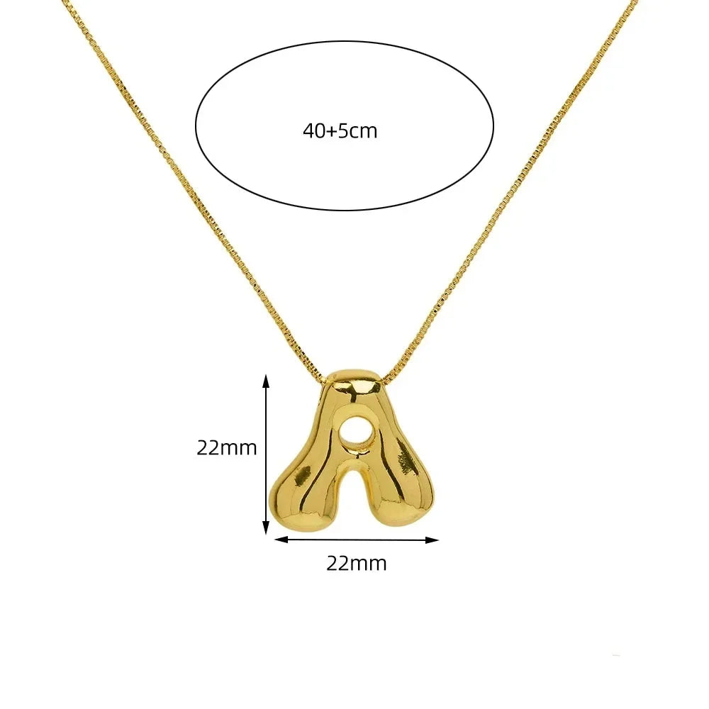 Dainty gold-tone initial letter pendant necklace for women. Personalized statement jewelry & everyday accessory.