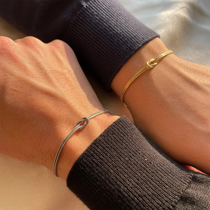 Elegant minimalist Endless Knot bracelet in polished stainless steel. Water-resistant unisex jewelry.