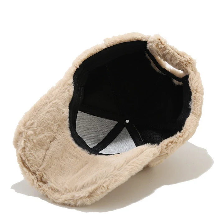 Plush faux fur cap for women, an adjustable and warm winter accessory offering cozy style.