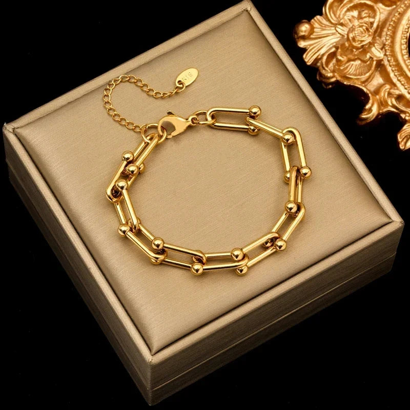 Detailed view of polished golden links on a women's elegant fashion link chain necklace.