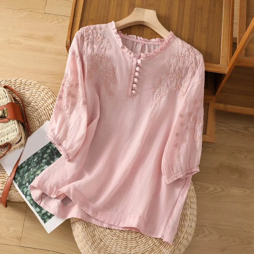 Stylish women's embroidered top with a button front, casual chic design, and intricate embroidery detail.