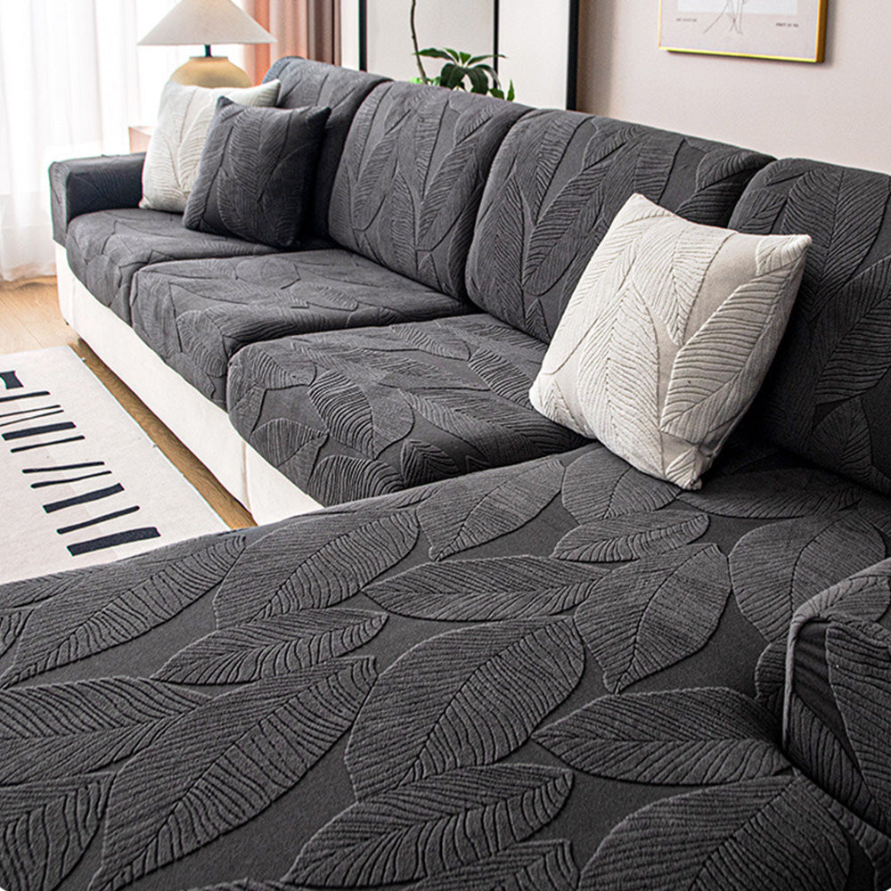 Protect your sofa with a stylish jacquard leaf print waterproof stretch slipcover, ideal for pets & easy to wash.
