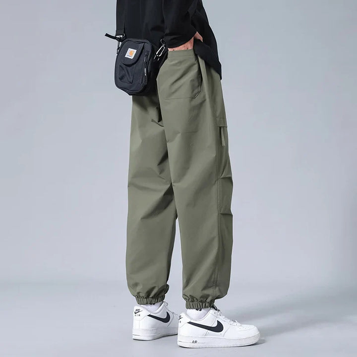 Durable men's workout joggers featuring secure zipper pockets. Essential athletic pants for gym or active lifestyle.