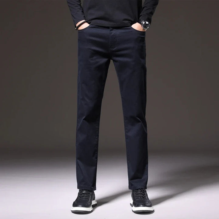 Men's versatile khaki cotton chino trousers paired with a classic shirt, creating a comfortable smart-casual look.