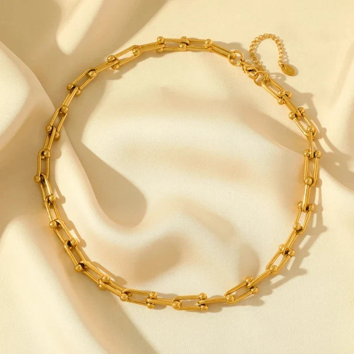 Shimmering gold polished link chain jewelry for women, an elegant fashion statement.