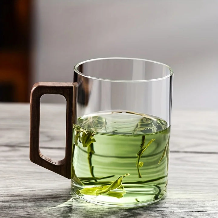 Modern glass coffee & tea mug with heat-resistant borosilicate and a unique ergonomic walnut wood handle.