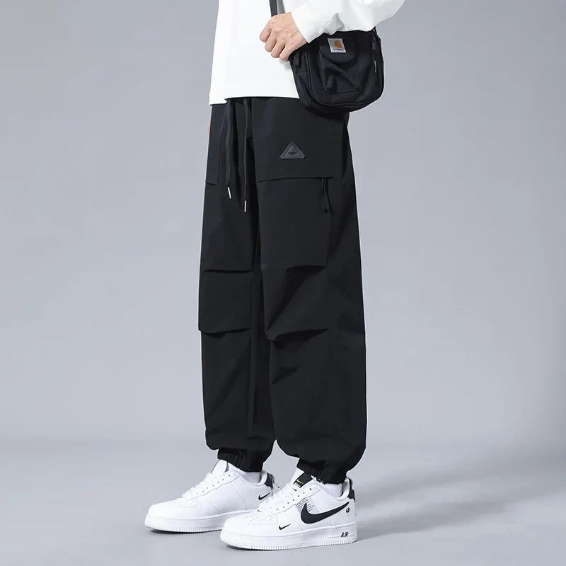 Modern men's activewear joggers with secure zipper pockets & tapered fit. Great for utility, comfort, & casual wear.